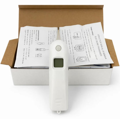 White digital thermometer in front of an open box with instructions on a white background